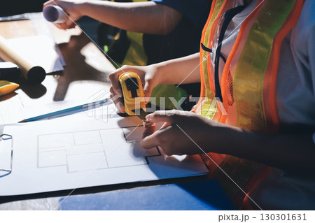 Closeup of team of industrial engineers meeting analyze machinery blueprints consult project on table in manufacturing factory. Working in manufacturing plant or production plant. 130301631
