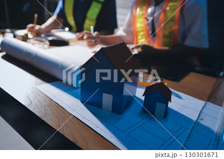 Closeup of team of industrial engineers meeting analyze machinery blueprints consult project on table in manufacturing factory. Working in manufacturing plant or production plant. 130301671