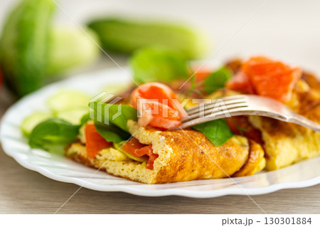 Omelet with red fish and fresh herbs Omelet with red fish and fresh herbs 130301884