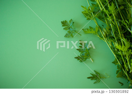 Fresh bunch parsley from above on a green surface 130301892