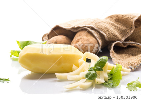 Nutritious potatoes: whole, peeled and sliced on a white background 130301900