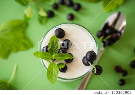 Blackcurrant in homemade yogurt, top view Blackcurrant in homemade yogurt, top view 130301905