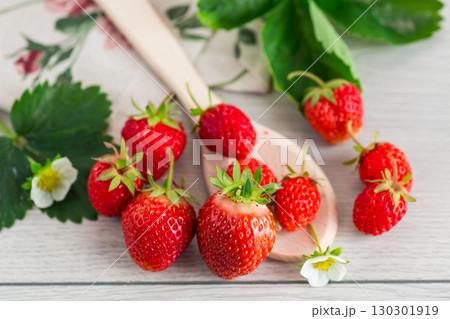 Top view of red strawberries on a light wooden table 130301919