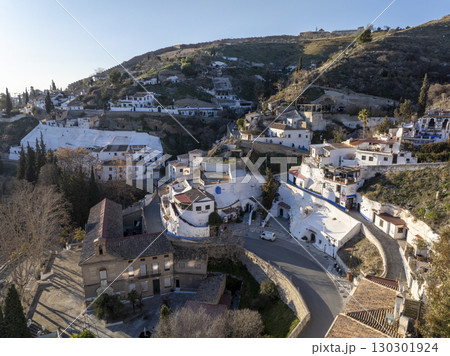 Sacromonte District in Granada, Spain. Aerial drone footage of the Traditional White Caved Dwellings at Sunset Light. 130301924