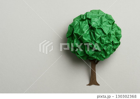 Paper art eco tree with green foliage and brown trunk on white background, symbolizing sustainability, creativity, and environmental awareness in minimalist style Paper art eco tree with green foliage and brown trunk on white background, symbolizing sustainability, creativity, and environmental awareness in minimalist style 130302368