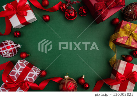 Christmas Gifts and Ornaments Border on Green Background Christmas Gifts and Ornaments Border on Green Background 130302823