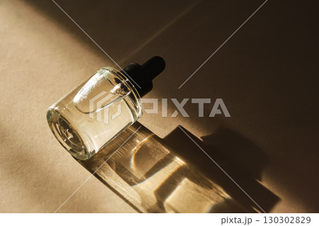 Natural facial oil with beautiful highlights on a beige background. 130302829