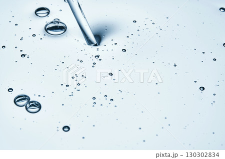 The texture of hyaluronic cleansing for the face or serum in blue tones. The texture of hyaluronic cleansing for the face or serum in blue tones. 130302834