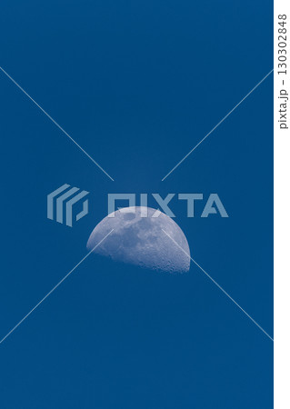 Half Moon Visible in Clear Blue Daytime Sky Half Moon Visible in Clear Blue Daytime Sky 130302848