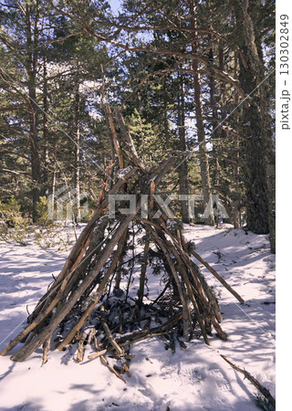 A rudimentary log cabin in the snowy forest A rudimentary log cabin in the snowy forest 130302849