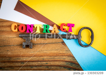 Contract agreement concept with colorful letters and vintage key on wooden desk Contract agreement concept with colorful letters and vintage key on wooden desk 130303209