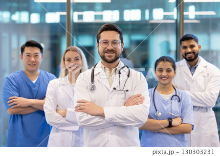 A team of diverse healthcare professionals confidently smiling in a modern hospital setting. Showcasing teamwork and dedication in providing quality medical care and fostering trust with patients. 130303231