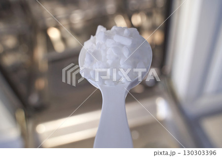 Close up of spoon with crushed ice in a kitchen setting Close up of spoon with crushed ice in a kitchen setting 130303396