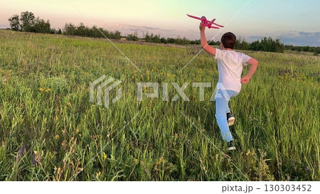 Childhood adventure in the countryside, Happy child playing with plane outdoors, Boy holding toy airplane over tall grass, Dreaming of flying on a sunny day, Exploring endless fields and blue skies Childhood adventure in the countryside, Happy child playing with plane outdoors, Boy holding toy airplane over tall grass, Dreaming of flying on a sunny day, Exploring endless fields and blue skies 130303452