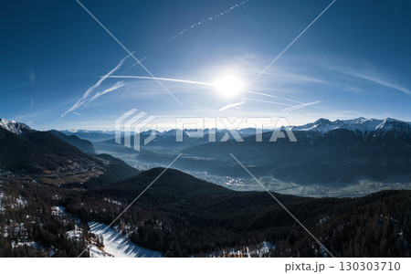 Aerial View of Alpine Valley with River and Mountains in Winter Sunlight. Pano Aerial View of Alpine Valley with River and Mountains in Winter Sunlight. Pano 130303710
