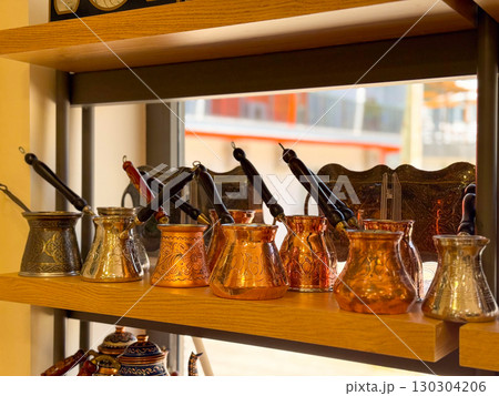 Copper and brass Turkish coffee pots with engraved designs. Traditional coffee preparation, cultural heritage, and artisanal craftsmanship. 130304206