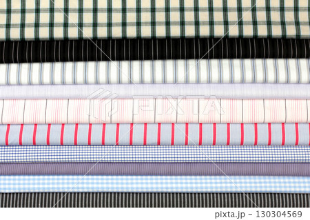 Variety of striped and checkered fabrics displayed in a neat horizontal arrangement 130304569