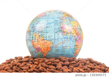 World globe on a bed of coffee beans showcasing global coffee origins and trade World globe on a bed of coffee beans showcasing global coffee origins and trade 130304571