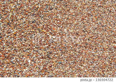 Textured close-up of colorful sand grains on a sunny beach in summer Textured close-up of colorful sand grains on a sunny beach in summer 130304722