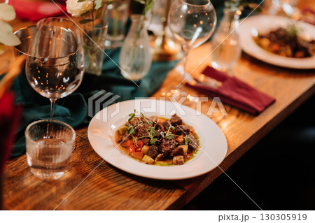 Elegant gourmet beef stew served at a romantic candlelit dinner celebration Elegant gourmet beef stew served at a romantic candlelit dinner celebration 130305919