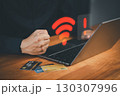 Male user using a laptop computer to connect to Wi-Fi, with clenched fist facing internet connectivity issue on laptop during online payment transaction, network failure, or technology disruption. 130307996