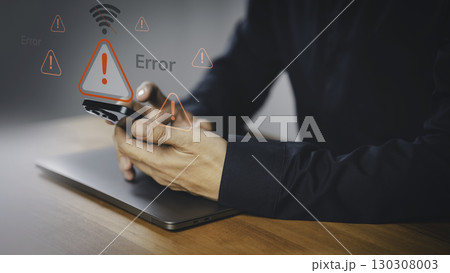 Person holding a smartphone with warning icon and a no Wi-Fi signal symbol. Idea for IT security service and digital risk content, a digital error, internet connection failure, malware, data breaches. Person holding a smartphone with warning icon and a no Wi-Fi signal symbol. Idea for IT security service and digital risk content, a digital error, internet connection failure, malware, data breaches. 130308003