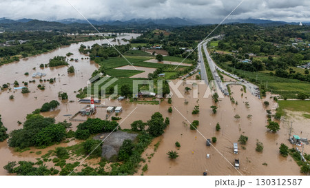 Aerial view of the road flood by Kok river rising during heavy rain in Chiang Rai province, Thailand. Aerial view of the road flood by Kok river rising during heavy rain in Chiang Rai province, Thailand. 130312587