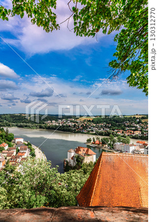 Panoramic view of Passau. Aerial skyline of old town from Veste Oberhaus castle . Confluence of three rivers Danube, Inn, Ilz, Bavaria, Germany. Vertical photo Panoramic view of Passau. Aerial skyline of old town from Veste Oberhaus castle . Confluence of three rivers Danube, Inn, Ilz, Bavaria, Germany. Vertical photo 130312770