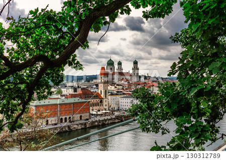 Panoramic view of Passau. View through tree branches. Aerial skyline of old town with beautiful reflection in Danube river, Bavaria, Germany. High quality photo Panoramic view of Passau. View through tree branches. Aerial skyline of old town with beautiful reflection in Danube river, Bavaria, Germany. High quality photo 130312789