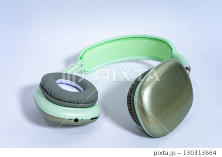 Modern wireless headphones lying on white background Modern wireless headphones lying on white background 130313664