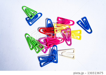 Colorful paper clips lying on white background 130313675