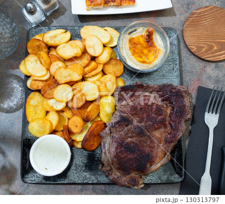 Entrecote with potato, julienne and cheese sauce Entrecote with potato, julienne and cheese sauce 130313797