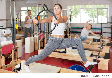 Young woman exercising with pilates ring Young woman exercising with pilates ring 130313856