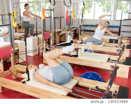 Young woman training her legs using straps 130313899