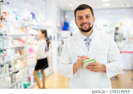 Portrait of male pharmacist working in drugstore 130314044