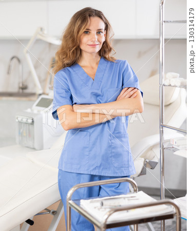 Skilled cosmetic doctor confidently stands Skilled cosmetic doctor confidently stands 130314179