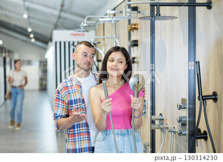Married couple chooses a shower head in hardware store 130314230