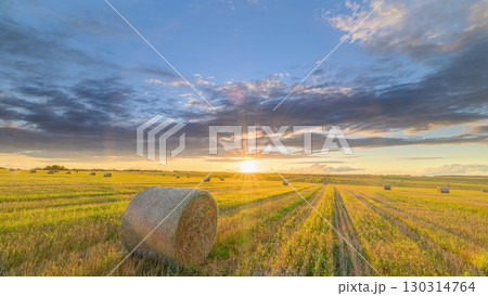 A Beautiful Golden Sunset Over Rolling Fields Filled with Bales of Hay Awaits You A Beautiful Golden Sunset Over Rolling Fields Filled with Bales of Hay Awaits You 130314764