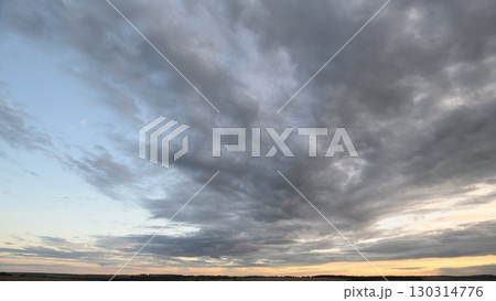 A Dramatic Cloudy Sky at Dusk Unfolds with Spectacular Colors and AweInspiring Beauty A Dramatic Cloudy Sky at Dusk Unfolds with Spectacular Colors and AweInspiring Beauty 130314776