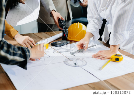 Engineer Teamwork Meeting, Drawing working on blueprint meeting for project working with partner on model building Engineer Teamwork Meeting, Drawing working on blueprint meeting for project working with partner on model building 130315072