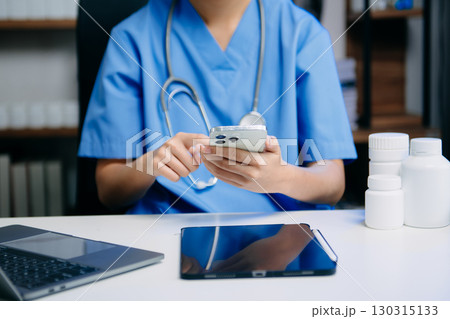 Medical technology concept. Doctor working with mobile phone and stethoscope and digital tablet laptop in modern office at hospital 130315133