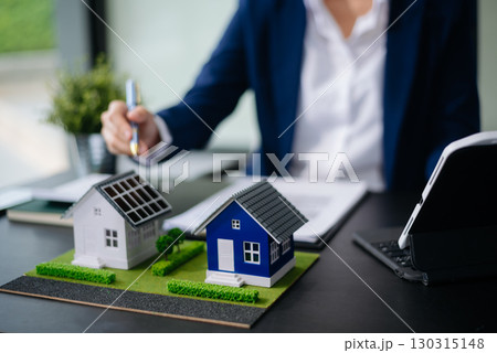 balancing the property sector The real estate agent is explaining the house style to see the house design and the purchase agreement. model house and comdo balancing the property sector The real estate agent is explaining the house style to see the house design and the purchase agreement. model house and comdo 130315148