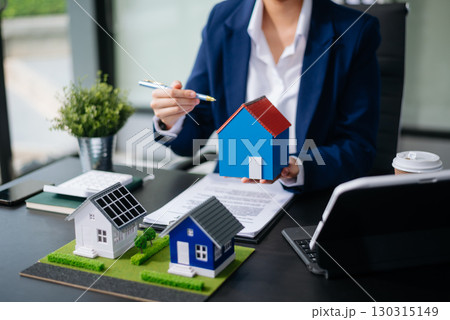 balancing the property sector The real estate agent is explaining the house style to see the house design and the purchase agreement. model house and comdo 130315149