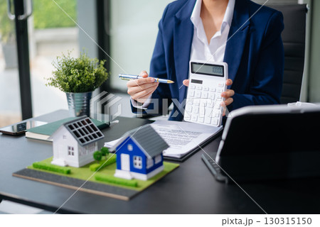 balancing the property sector The real estate agent is explaining the house style to see the house design and the purchase agreement. model house and comdo 130315150