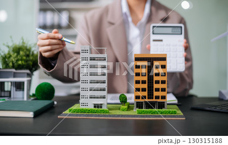 balancing the property sector The real estate agent is explaining the house style to see the house design and the purchase agreement. model house and comdo balancing the property sector The real estate agent is explaining the house style to see the house design and the purchase agreement. model house and comdo 130315188