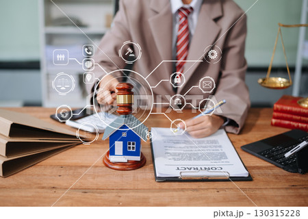 Real Estate Lawyer And House Foreclosure Law. House model, hammer judge gavel on table with white background. 130315228