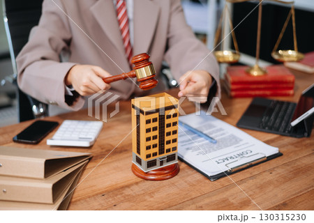 Real Estate Lawyer And House Foreclosure Law. House model, hammer judge gavel on table with white background. 130315230