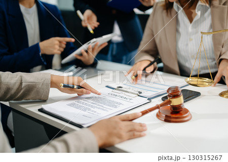 business people and lawyers discussing contract papers sitting at the table. Concepts of law, advice, legal services. 130315267