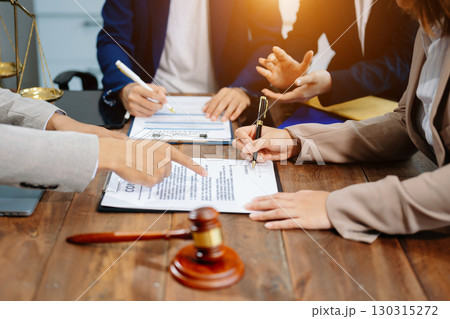 Business and lawyers discussing contract papers with brass scale on desk in office. Law, legal services, advice, justice and law Business and lawyers discussing contract papers with brass scale on desk in office. Law, legal services, advice, justice and law 130315272