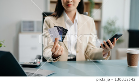 Financial owe, hand of asian woman sitting, holding credit card, stressed by calculate expense from invoice or bill, no money to pay 130315542